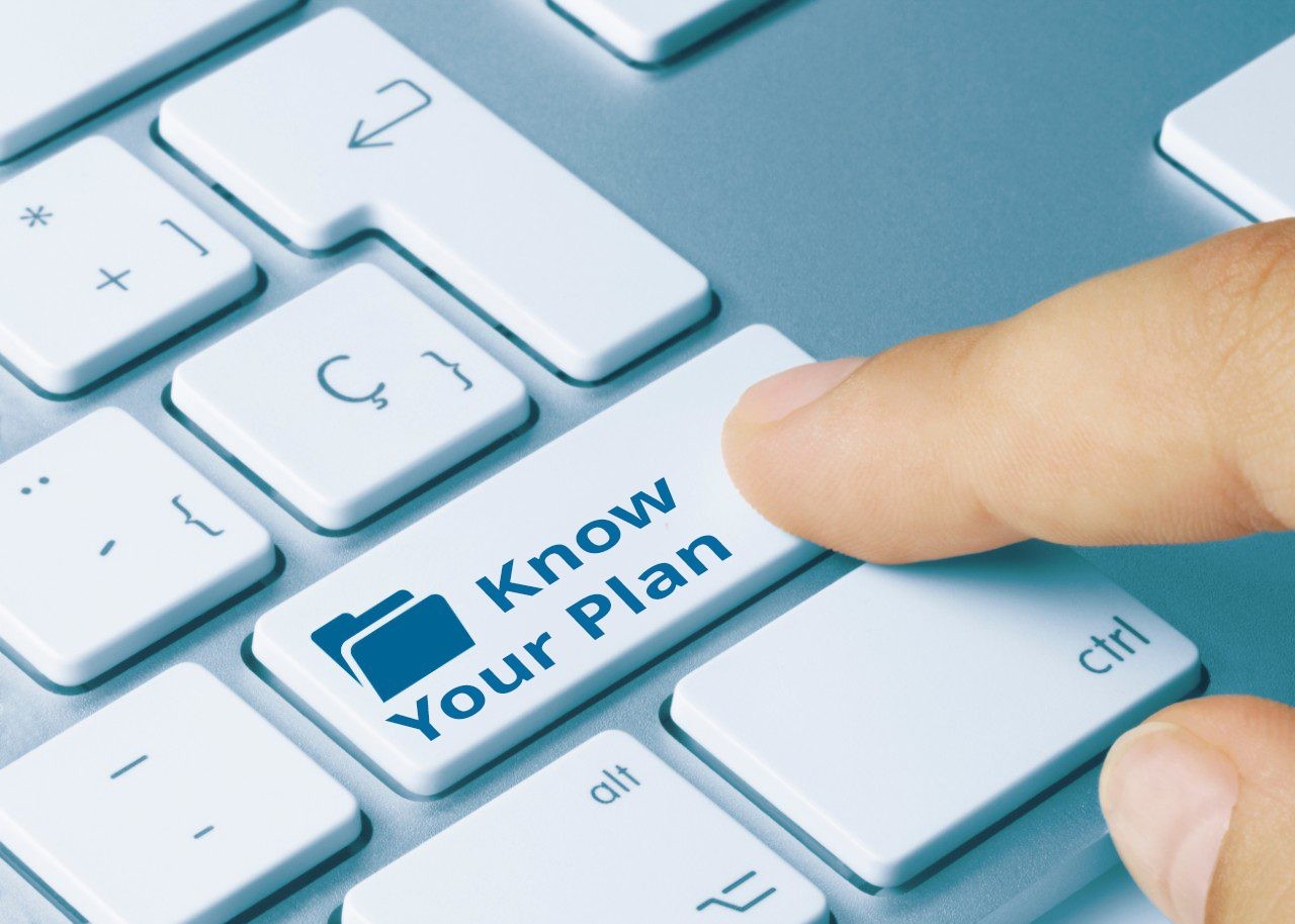 Keyboard with a finger clicking a key labeled "Know Your Plan" with a file icon on it.